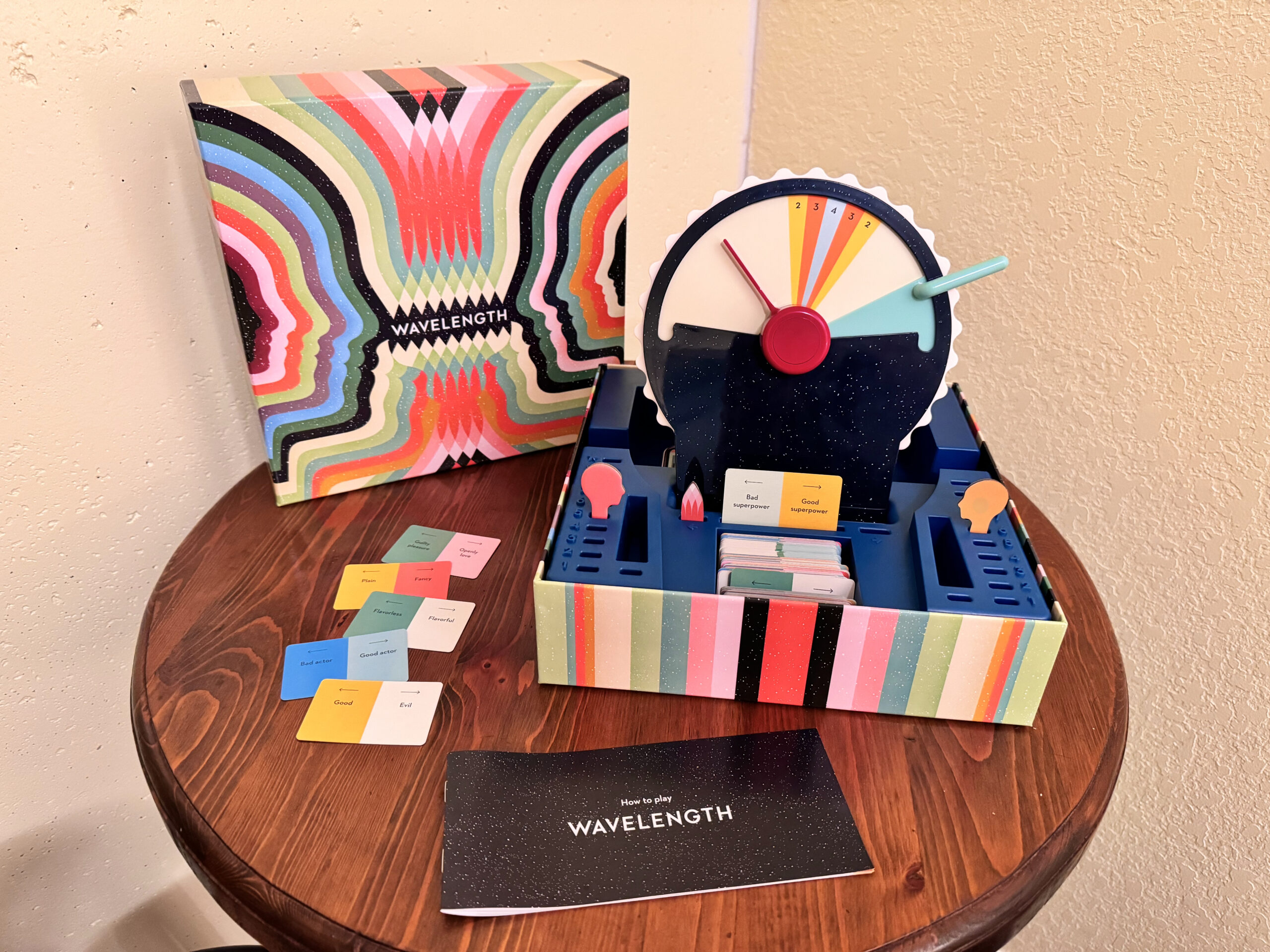 Wavelength board game setup with dial, clue cards and game components on a table.